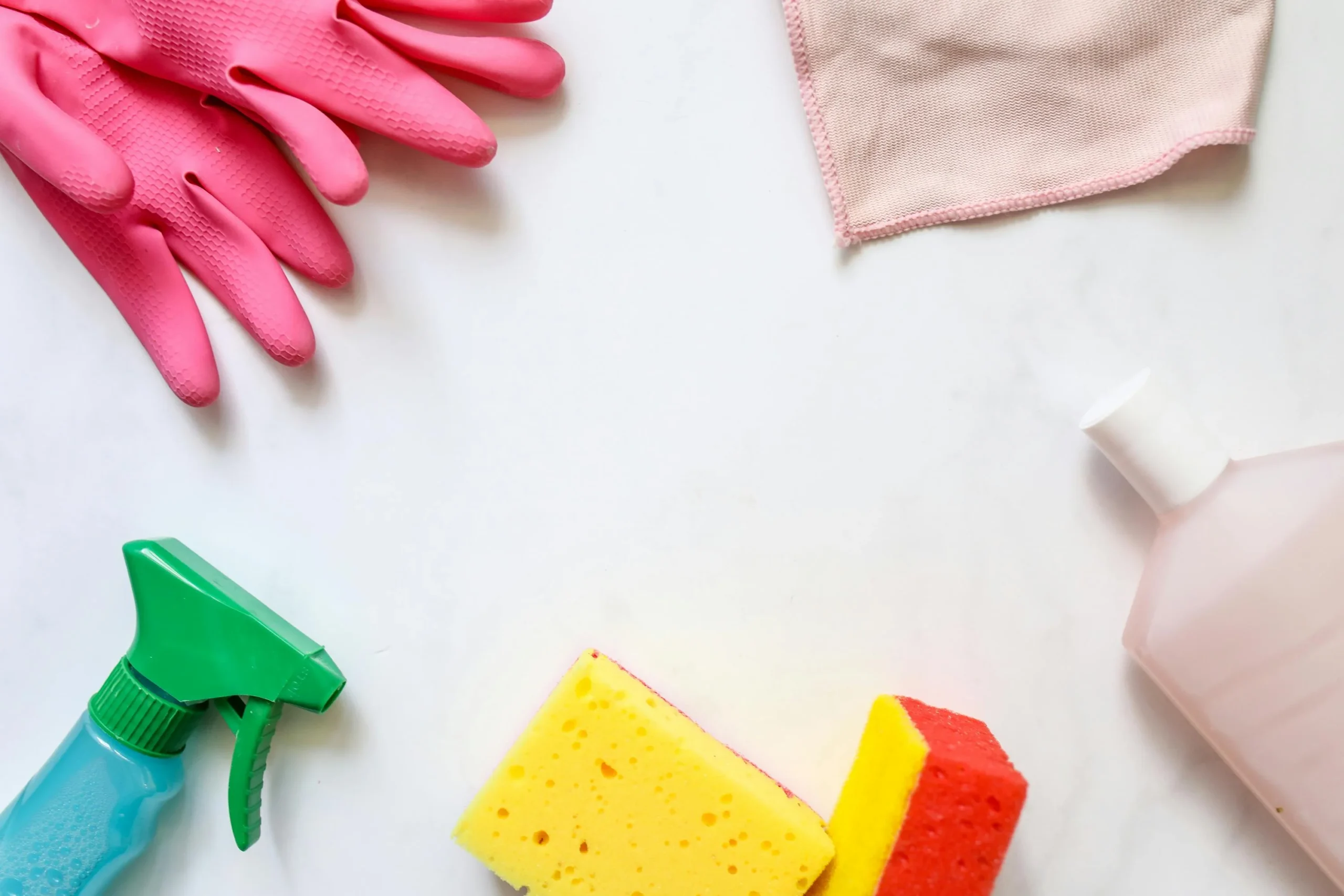 cleaning supplies with gloves bottles, and sponges