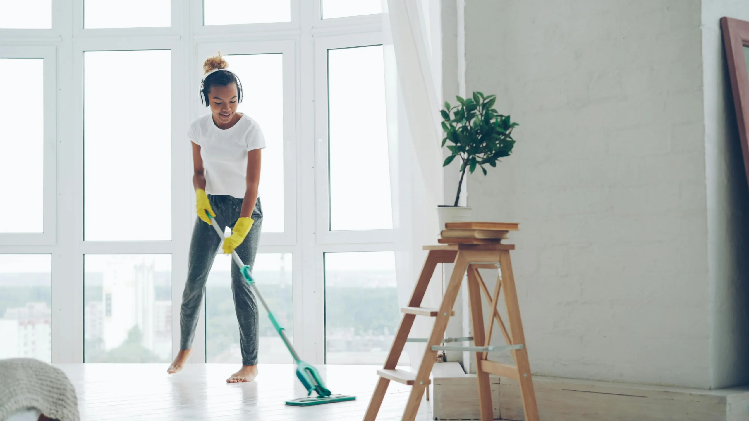 Picture of a worker in protective gear scrubbing the floor during professional end-of-tenancy cleaning services.